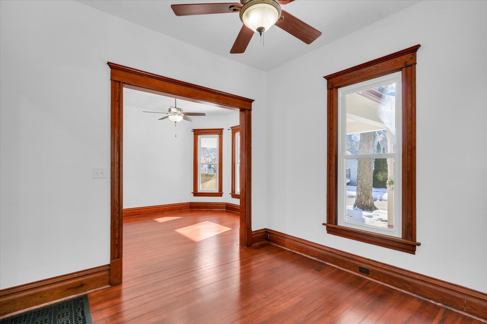 202 East Daggy Street Tuscola, IL 61953 - Photo 15 of 45 a view of an empty room with wooden floor and a window
