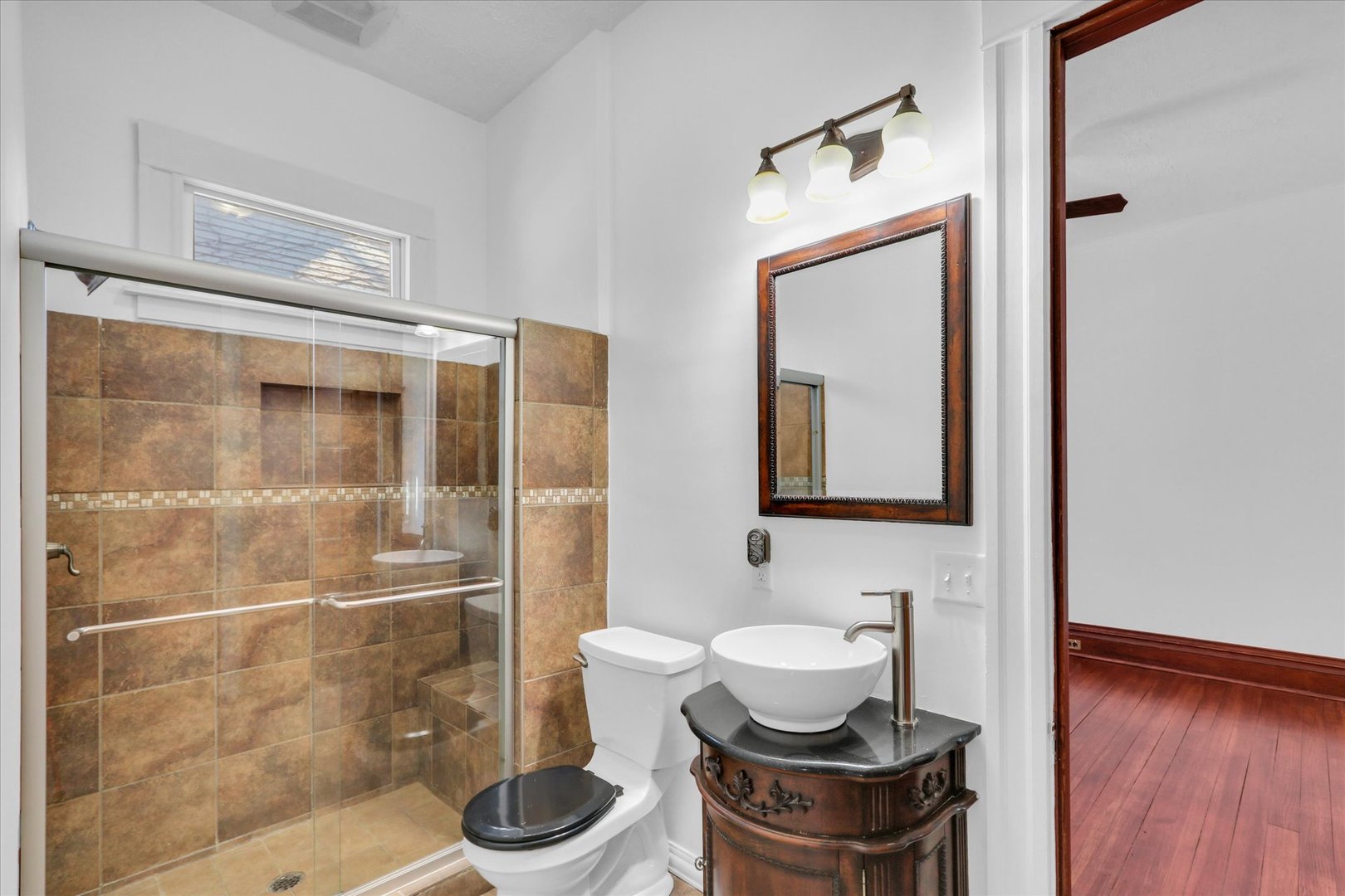202 East Daggy Street Tuscola, IL 61953 - Photo 17 of 45 a bathroom with a toilet a sink and a mirror