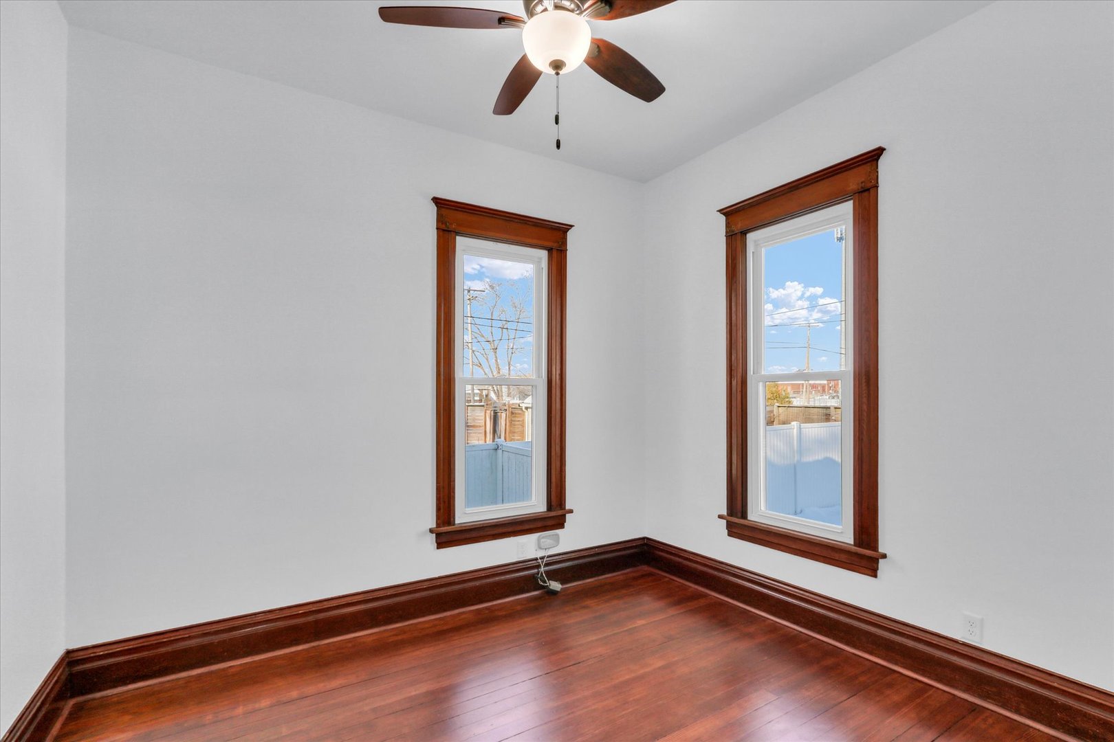 202 East Daggy Street Tuscola, IL 61953 - Photo 21 of 45 a view of an empty room with window and wooden floor