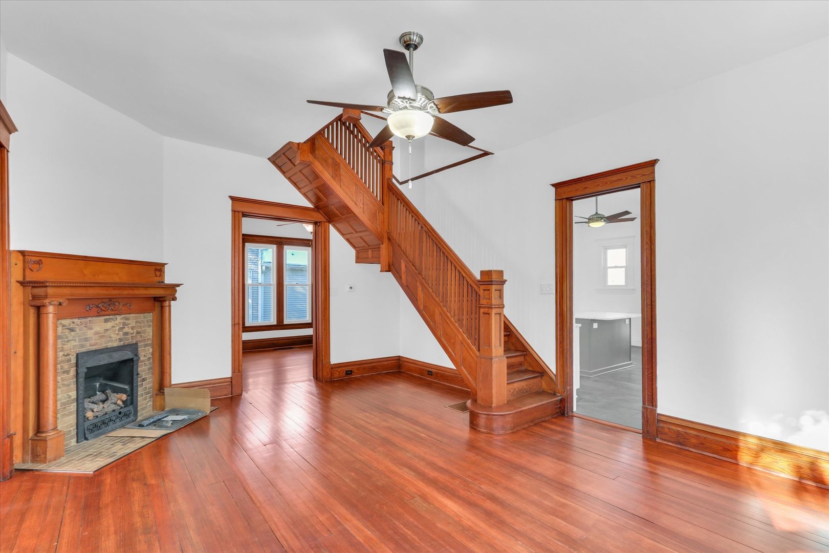 202 East Daggy Street Tuscola, IL 61953 - Photo 6 of 45 a view of staircase with a fireplace and wooden floor