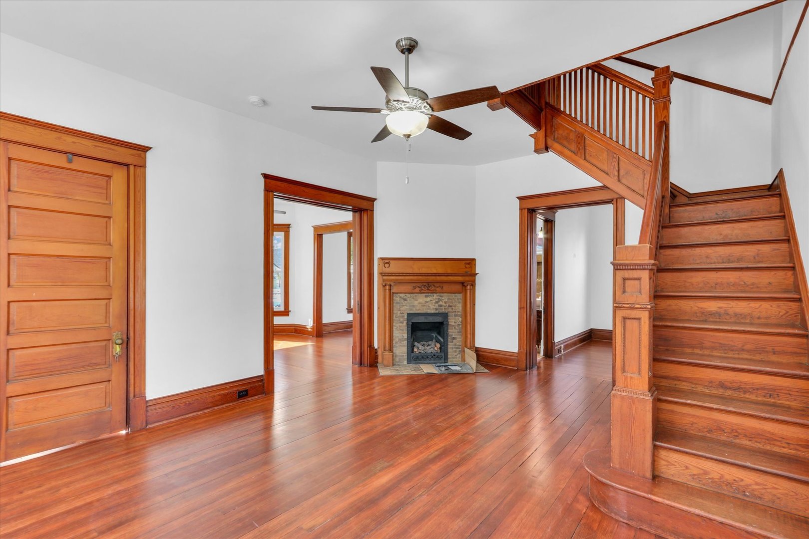 202 East Daggy Street Tuscola, IL 61953 - Photo 7 of 45 a view of empty room with wooden floor and fan