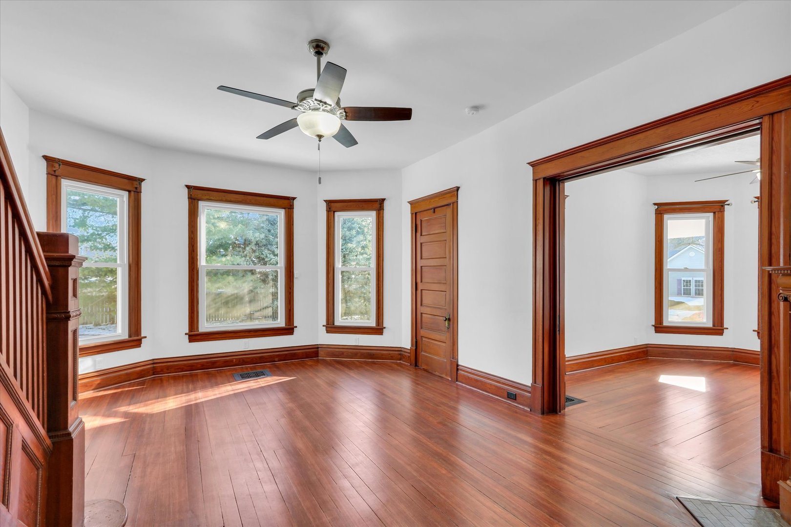 202 East Daggy Street Tuscola, IL 61953 - Photo 8 of 45 a view of an empty room with a window and wooden floor