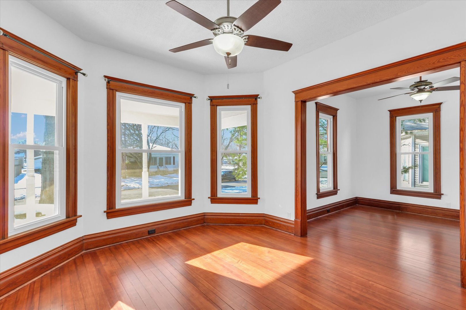 202 East Daggy Street Tuscola, IL 61953 - Photo 9 of 45 a view of an empty room with window and wooden floor