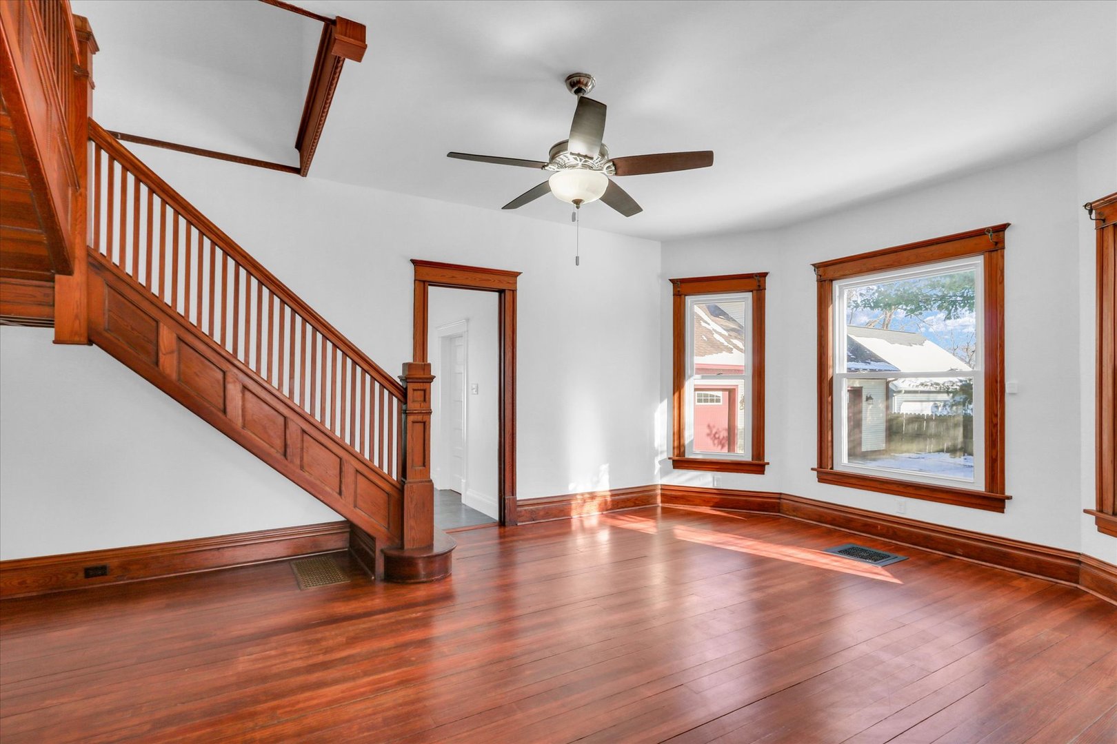 202 East Daggy Street Tuscola, IL 61953 - Photo 10 of 45 a view of an empty room with wooden floor and a window