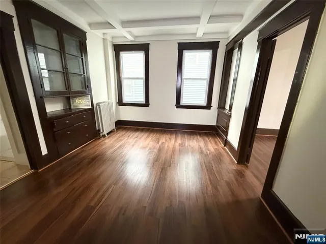 wooden floor in an empty room with wooden floor and windows