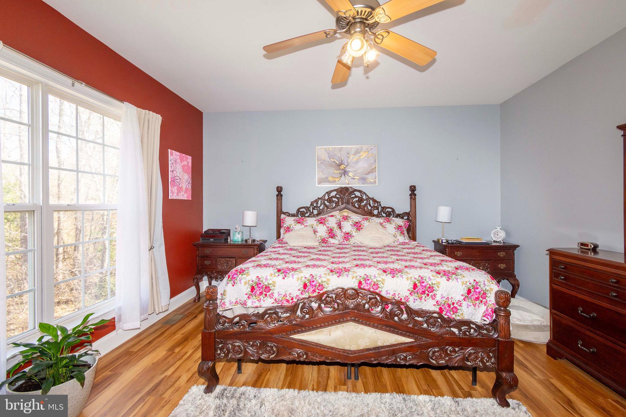 2203 Campbell Road Gordonsville, VA 22942 - Photo 15 of 53 a bedroom with a bed and a chandelier