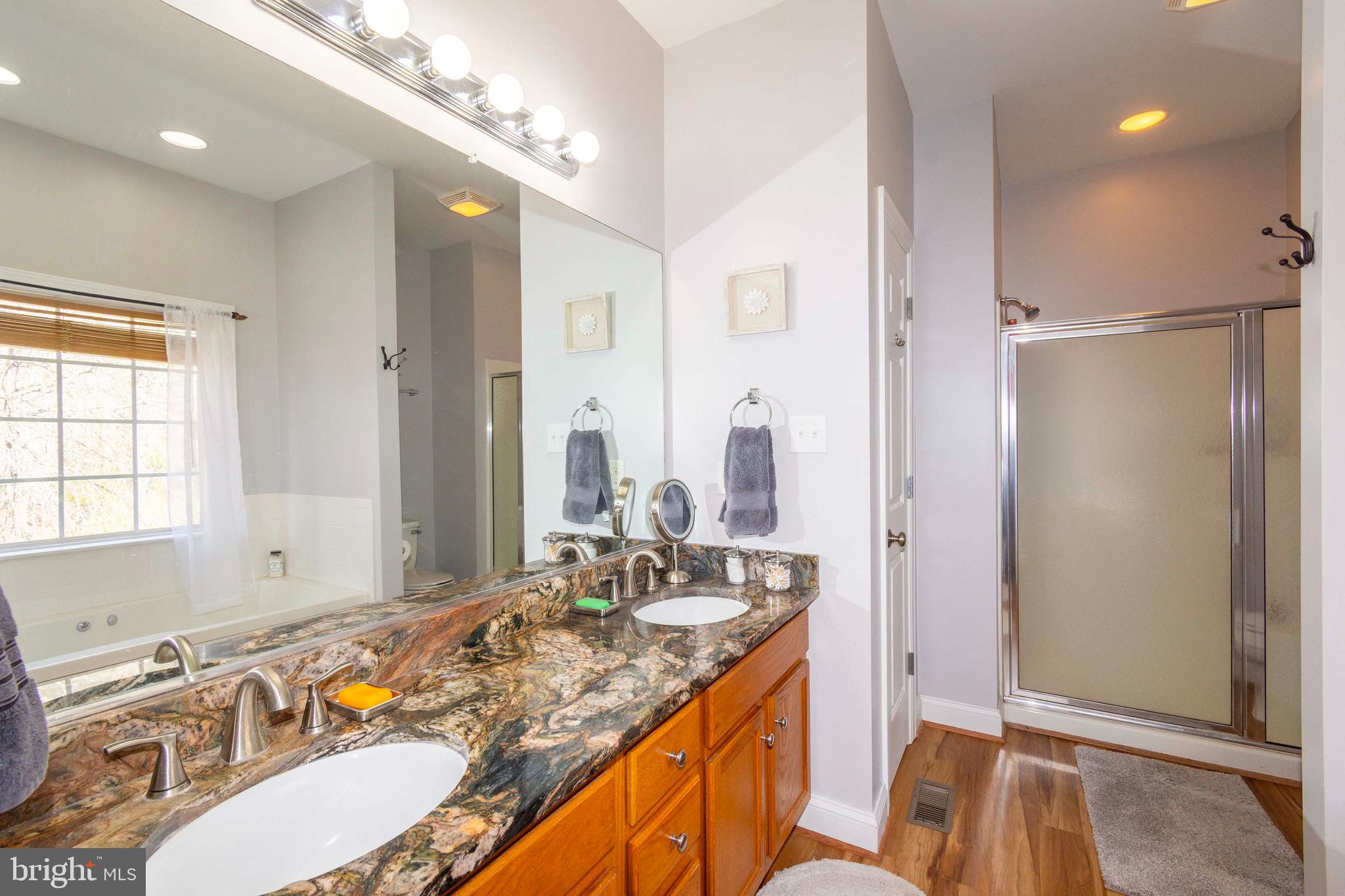 2203 Campbell Road Gordonsville, VA 22942 - Photo 18 of 53 a bathroom with a granite countertop sink and a mirror
