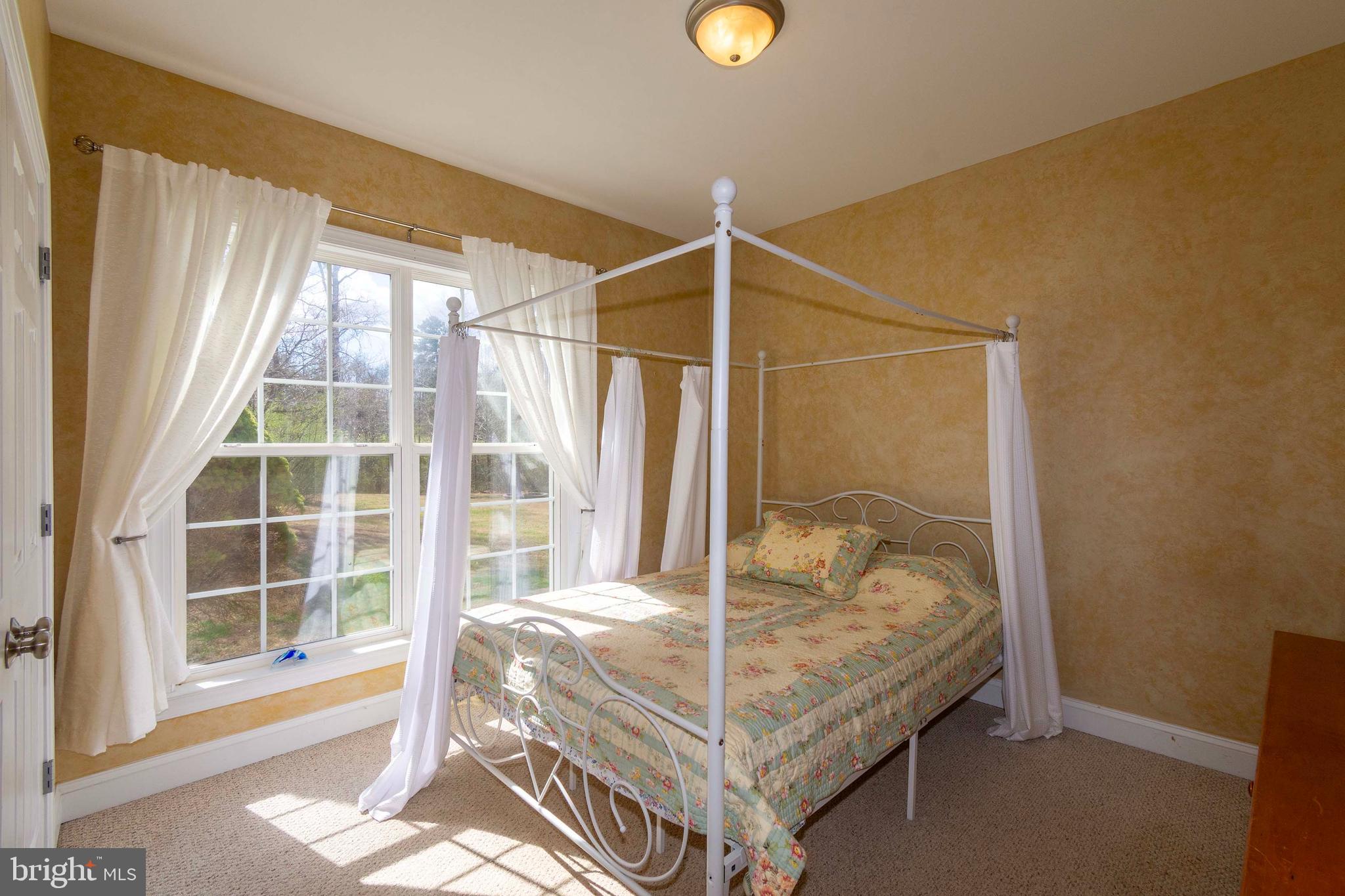 2203 Campbell Road Gordonsville, VA 22942 - Photo 20 of 53 a bed sitting in a bedroom next to a window