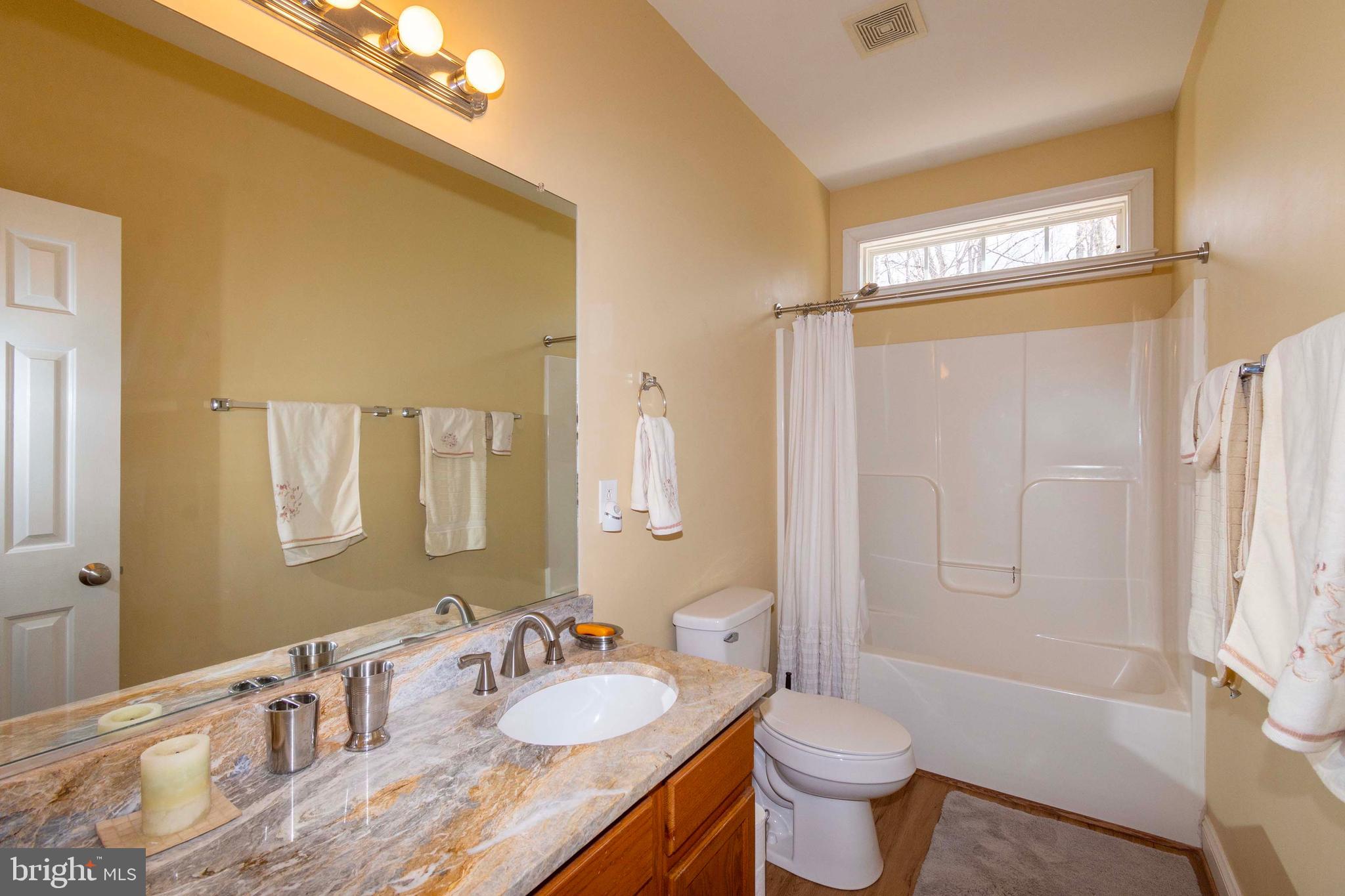2203 Campbell Road Gordonsville, VA 22942 - Photo 22 of 53 a bathroom with a granite countertop sink toilet and shower