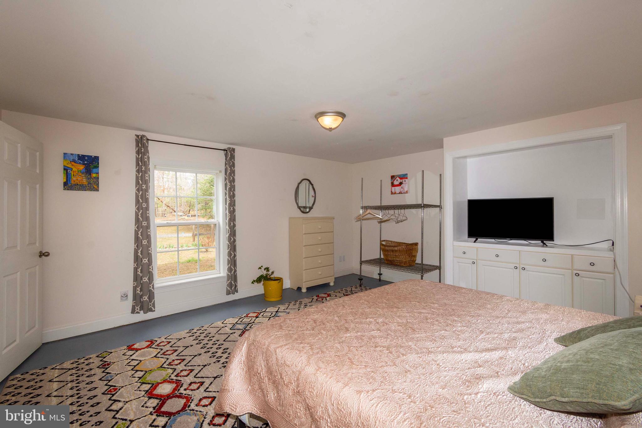 2203 Campbell Road Gordonsville, VA 22942 - Photo 26 of 53 a bedroom with a bed and a flat screen tv