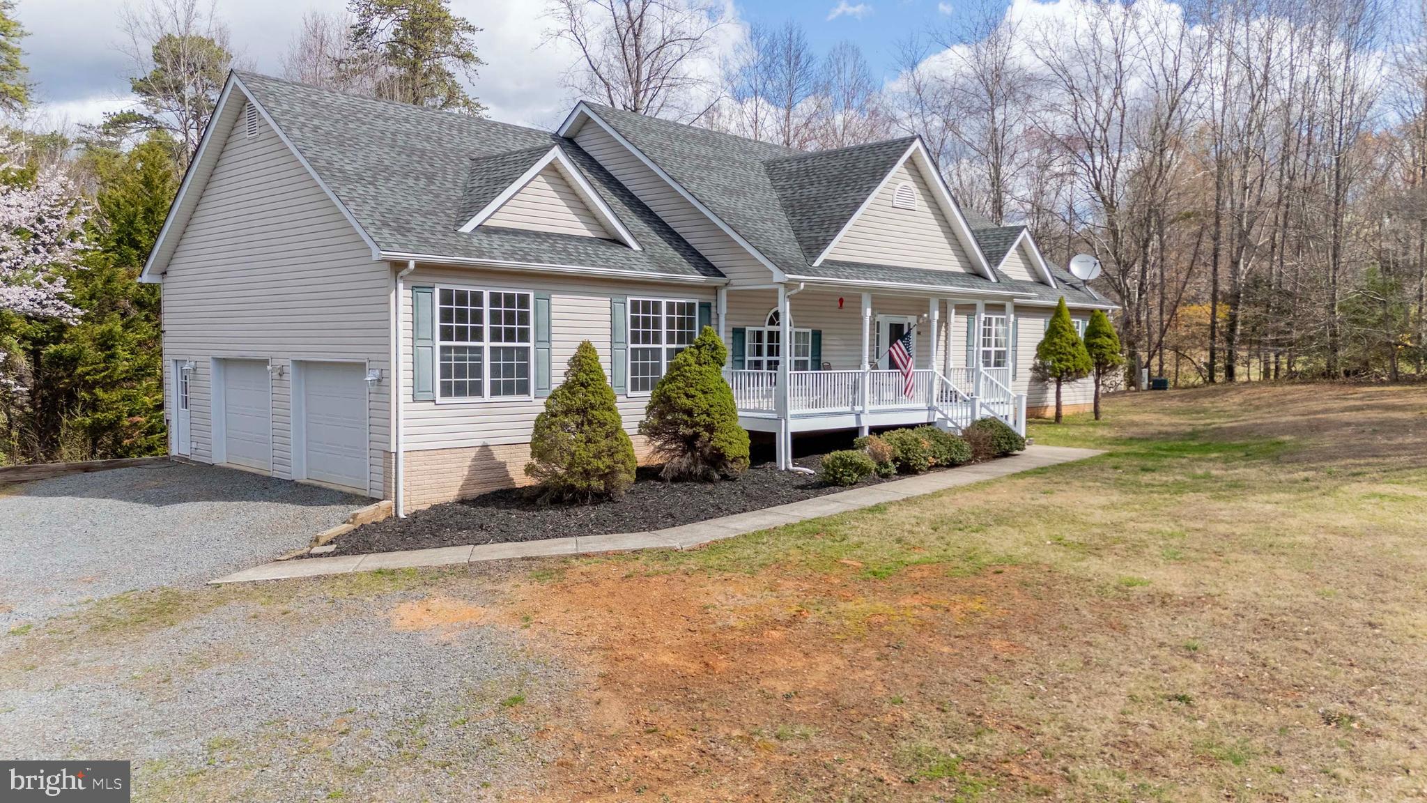 2203 Campbell Road Gordonsville, VA 22942 - Photo 4 of 53 a front view of a house with a yard and garage