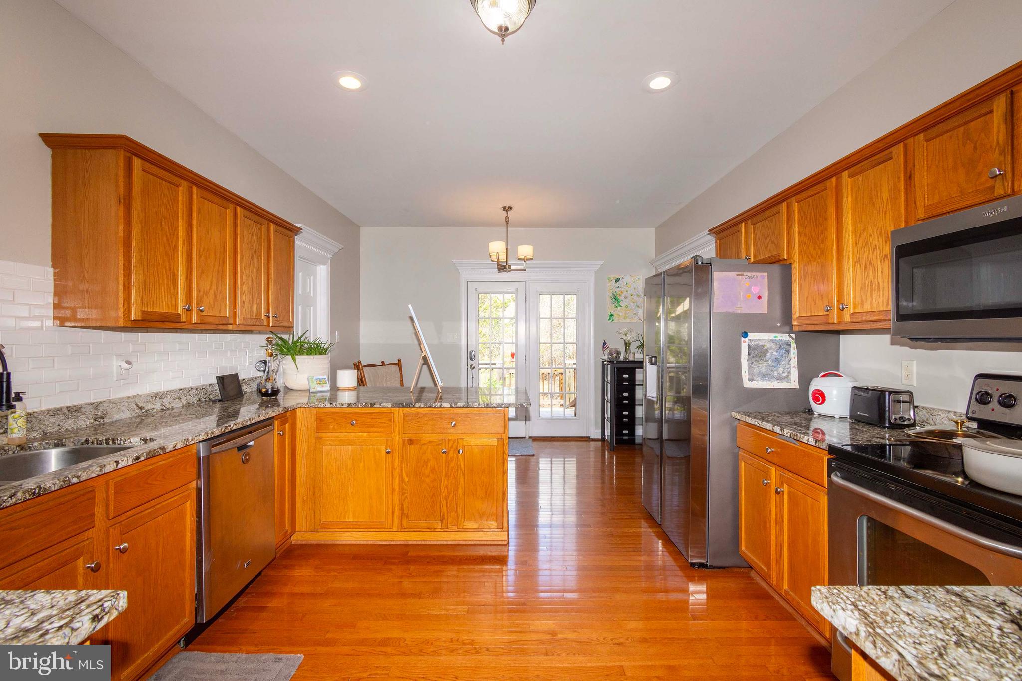 2203 Campbell Road Gordonsville, VA 22942 - Photo 10 of 53 a large kitchen with stainless steel appliances granite countertop a large stove top oven a sink dishwasher and cabinets with wooden floor
