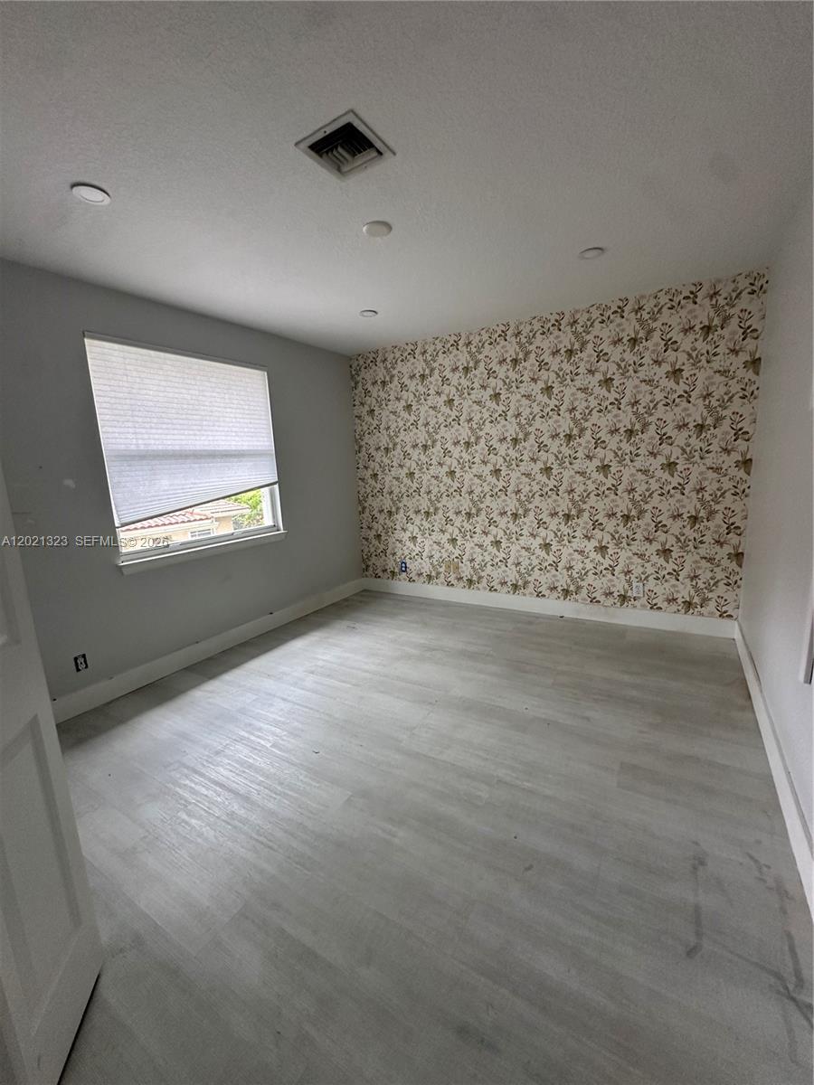 354 Mallard Road, Unit O Weston, FL 33327 - Photo 14 of 29 an empty room with wooden floor and windows