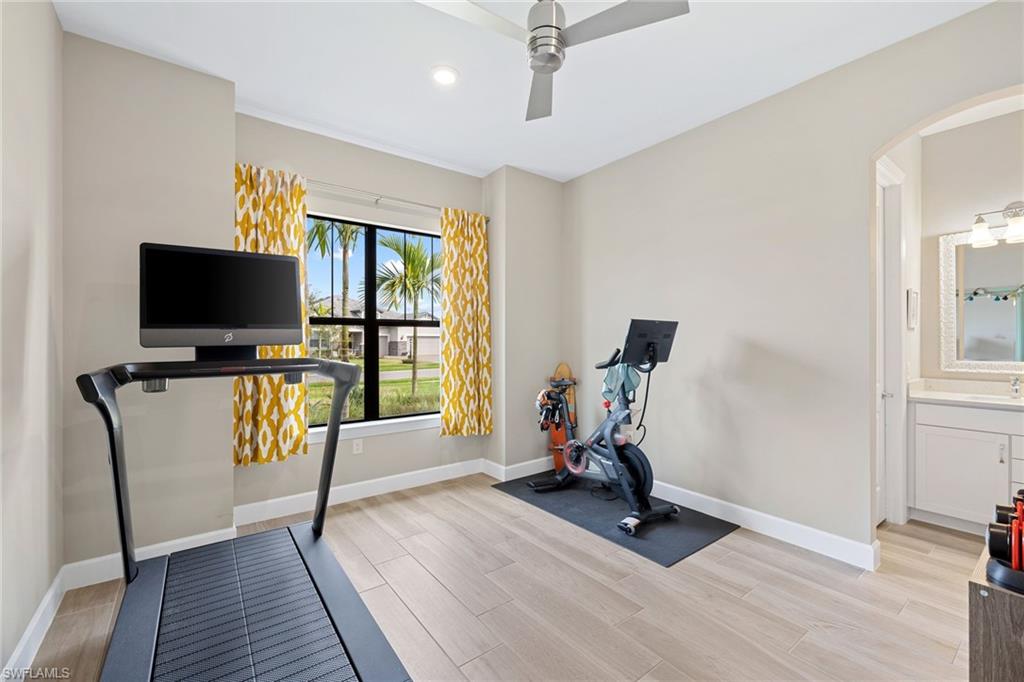 19134 Elston Way Estero, FL 33928 - Photo 25 of 35 a view of a workspace with furniture and a flat screen tv