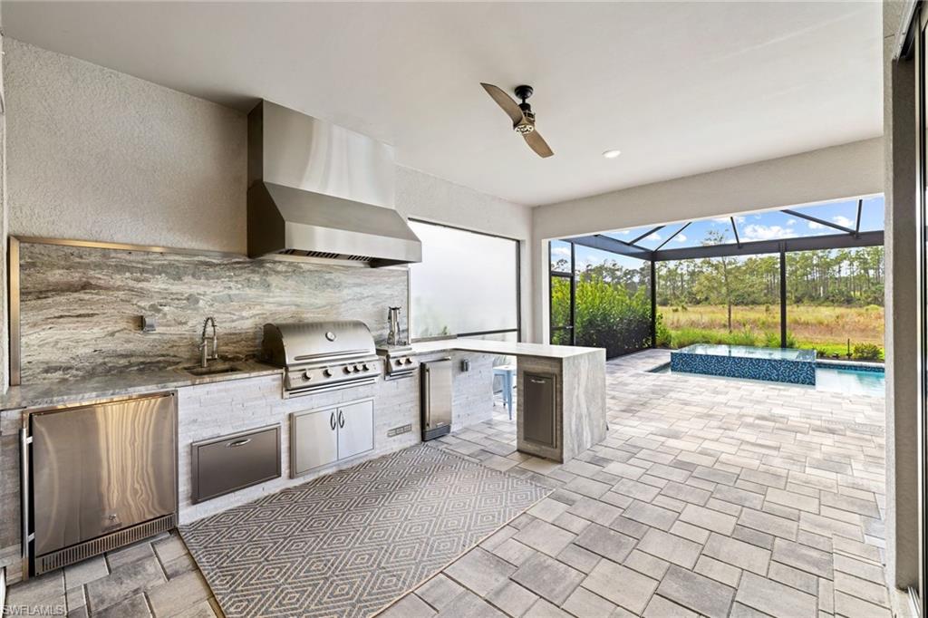 19134 Elston Way Estero, FL 33928 - Photo 7 of 35 a kitchen with a stove a sink and a refrigerator