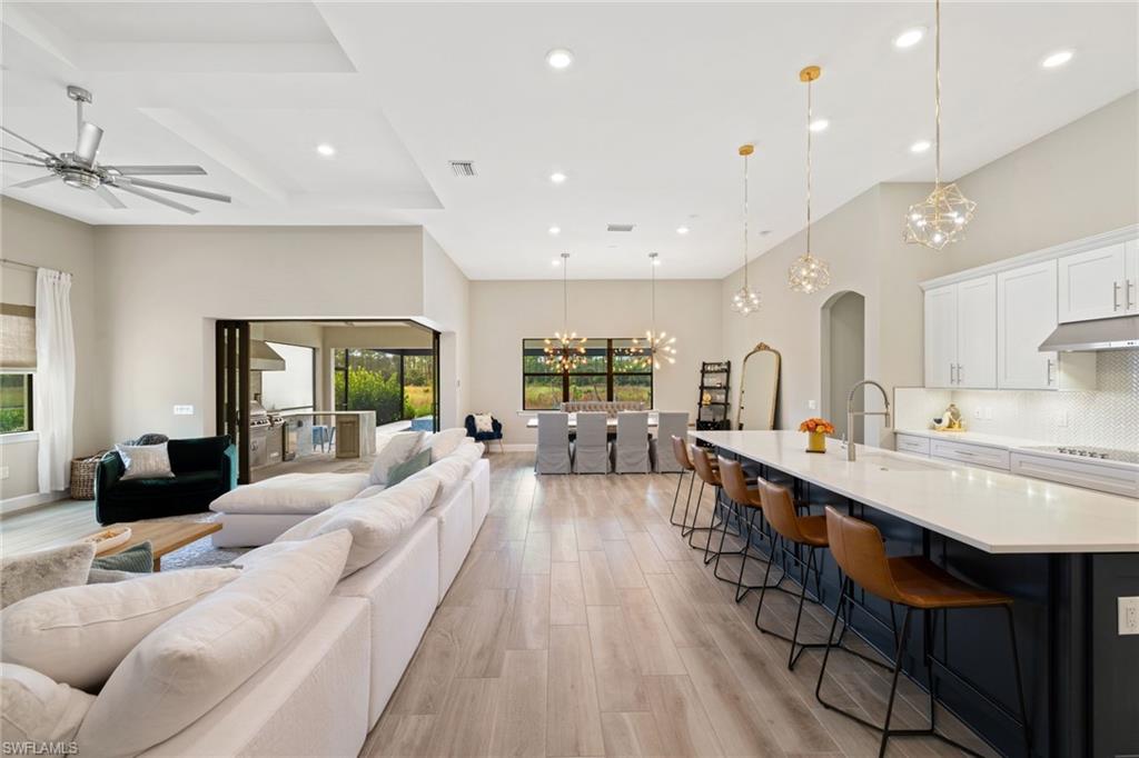 19134 Elston Way Estero, FL 33928 - Photo 8 of 35 a large living room with stainless steel appliances furniture a couch and a view of kitchen