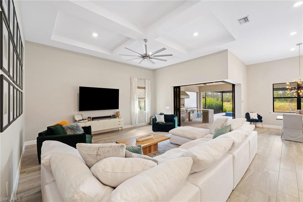 19134 Elston Way Estero, FL 33928 - Photo 9 of 35 a living room with furniture a flat screen tv and a large window