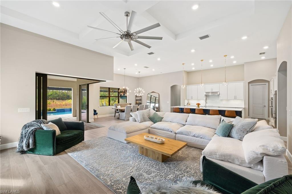 19134 Elston Way Estero, FL 33928 - Photo 10 of 35 a living room with furniture ceiling fan and a rug