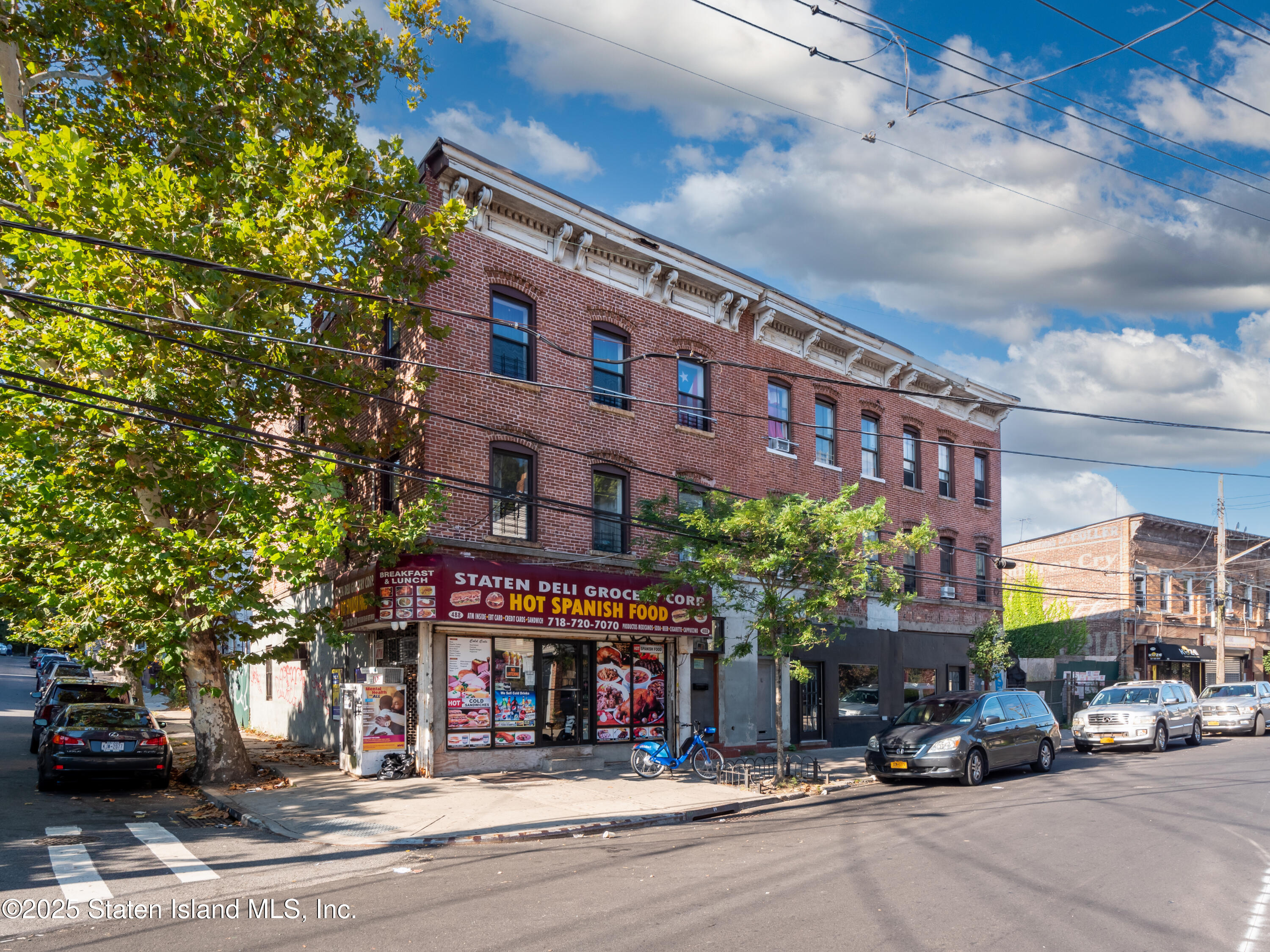 Undisclosed Address Staten Island, NY 10301 - Photo 3 of 7 a building with trees in front of it