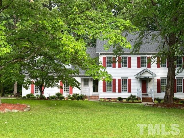 6408 Hampton Ridge Road Raleigh, NC 27603 - Photo 3 of 44 a front view of a house with a garden