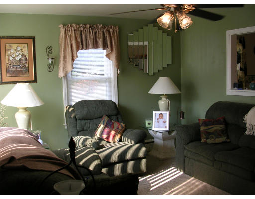 43 Durfee Road Tiverton, RI 02878 - Photo 4 of 6 a living room with furniture and a chandelier