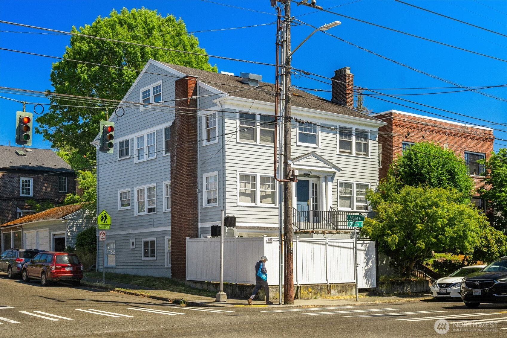 746 10th Avenue East Seattle, WA 98102 - Photo 2 of 34 a front view of a building with lot of cars and trees