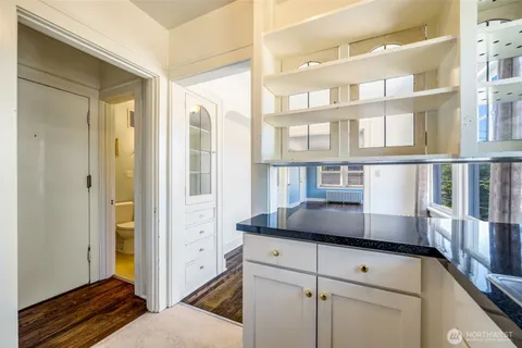 a living room with a bed and a window