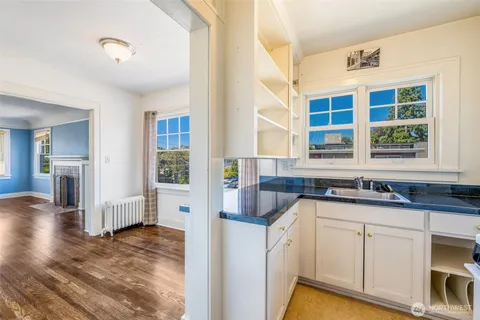 a kitchen with granite countertop a sink and cabinets