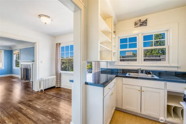 a kitchen with granite countertop a sink and cabinets
