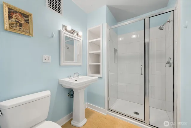 a bathroom with a sink mirror toilet and shower