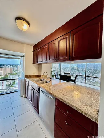 a kitchen with stainless steel appliances granite countertop a sink stove and granite counter top
