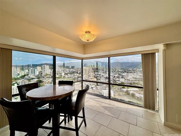 a dining room with furniture a chandelier and fireplace