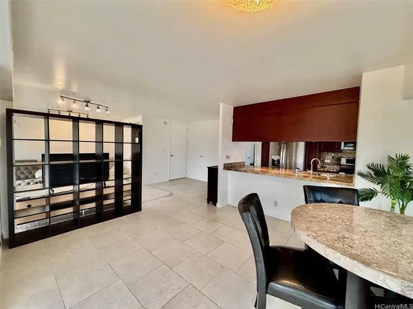 a dining room with furniture and a floor to ceiling window
