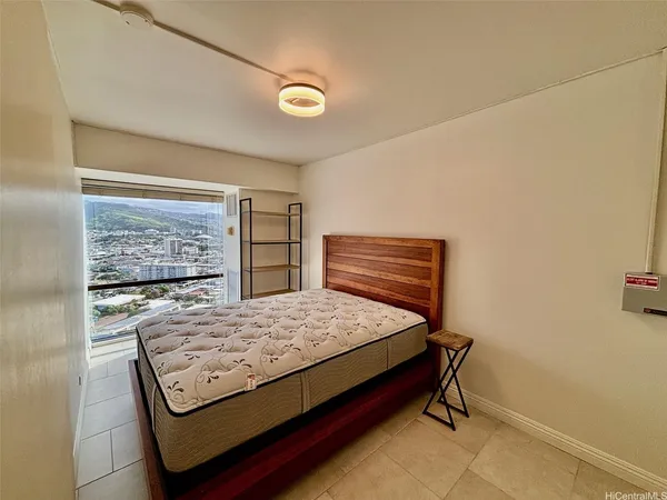 a bed sitting in a bedroom next to a window