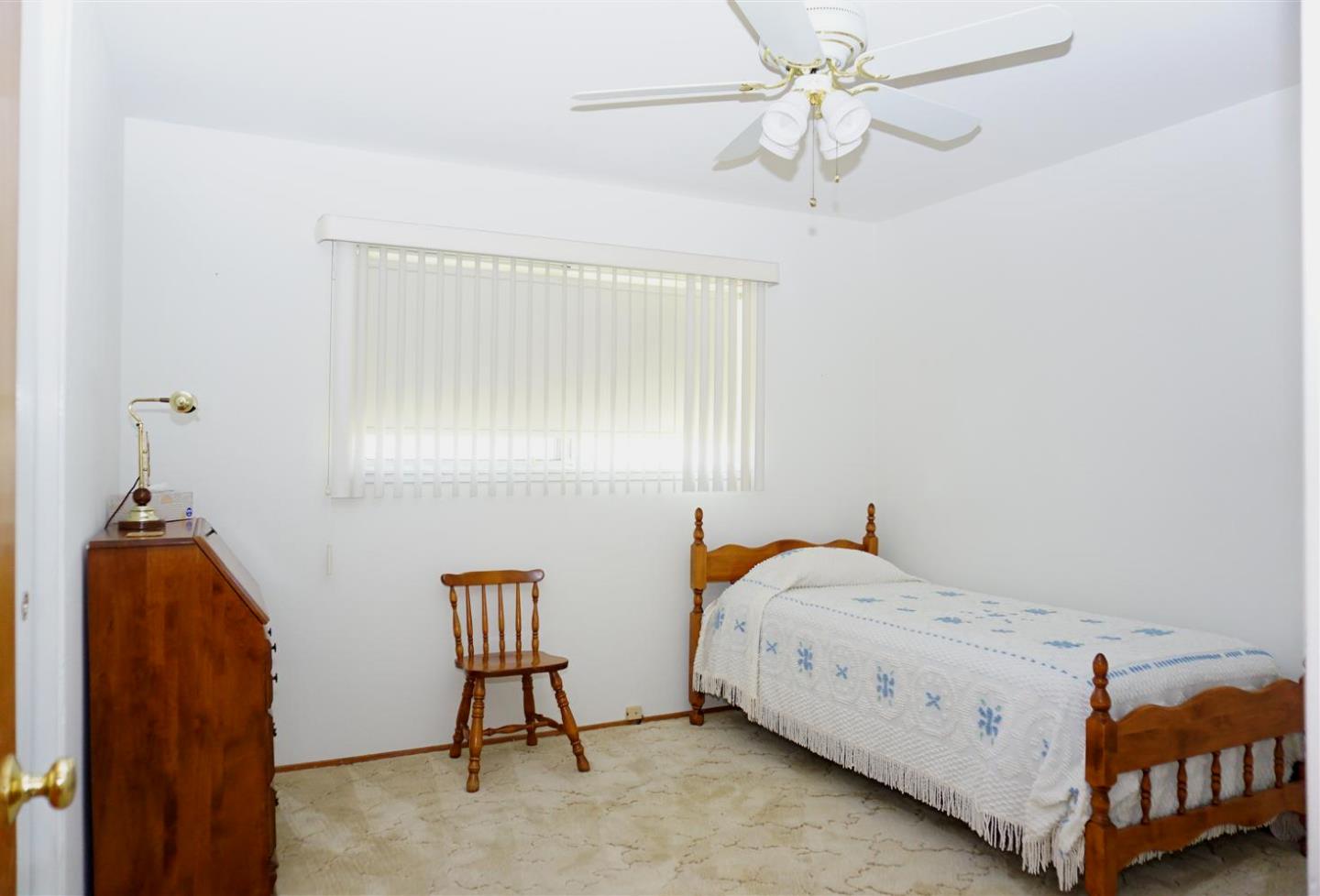1116 Buchanan Drive Santa Clara, CA 95051 - Photo 17 of 30 a bedroom with a bed and a chandelier