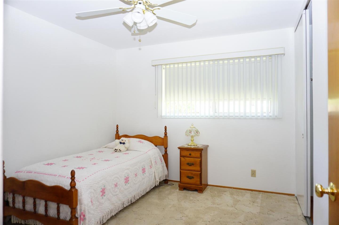 1116 Buchanan Drive Santa Clara, CA 95051 - Photo 18 of 30 a bedroom with a bed and a chandelier
