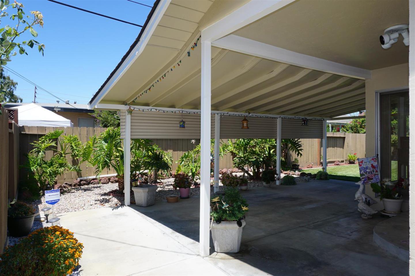 1116 Buchanan Drive Santa Clara, CA 95051 - Photo 28 of 30 a view of a patio with table and chairs potted plants and floor to ceiling window and potted plants