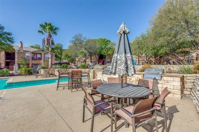 a view of a patio with a table and chairs