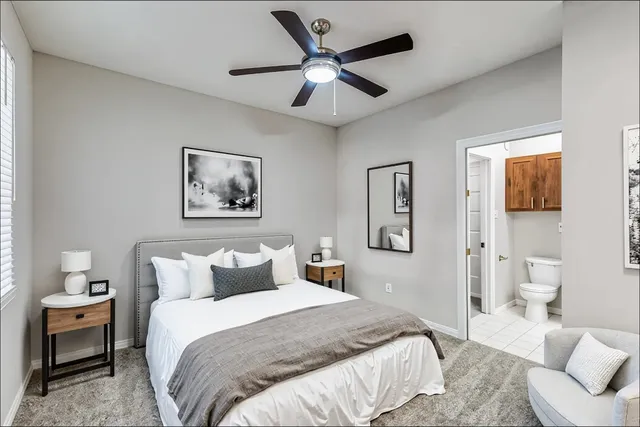 a bedroom with a bed and a painting on the wall