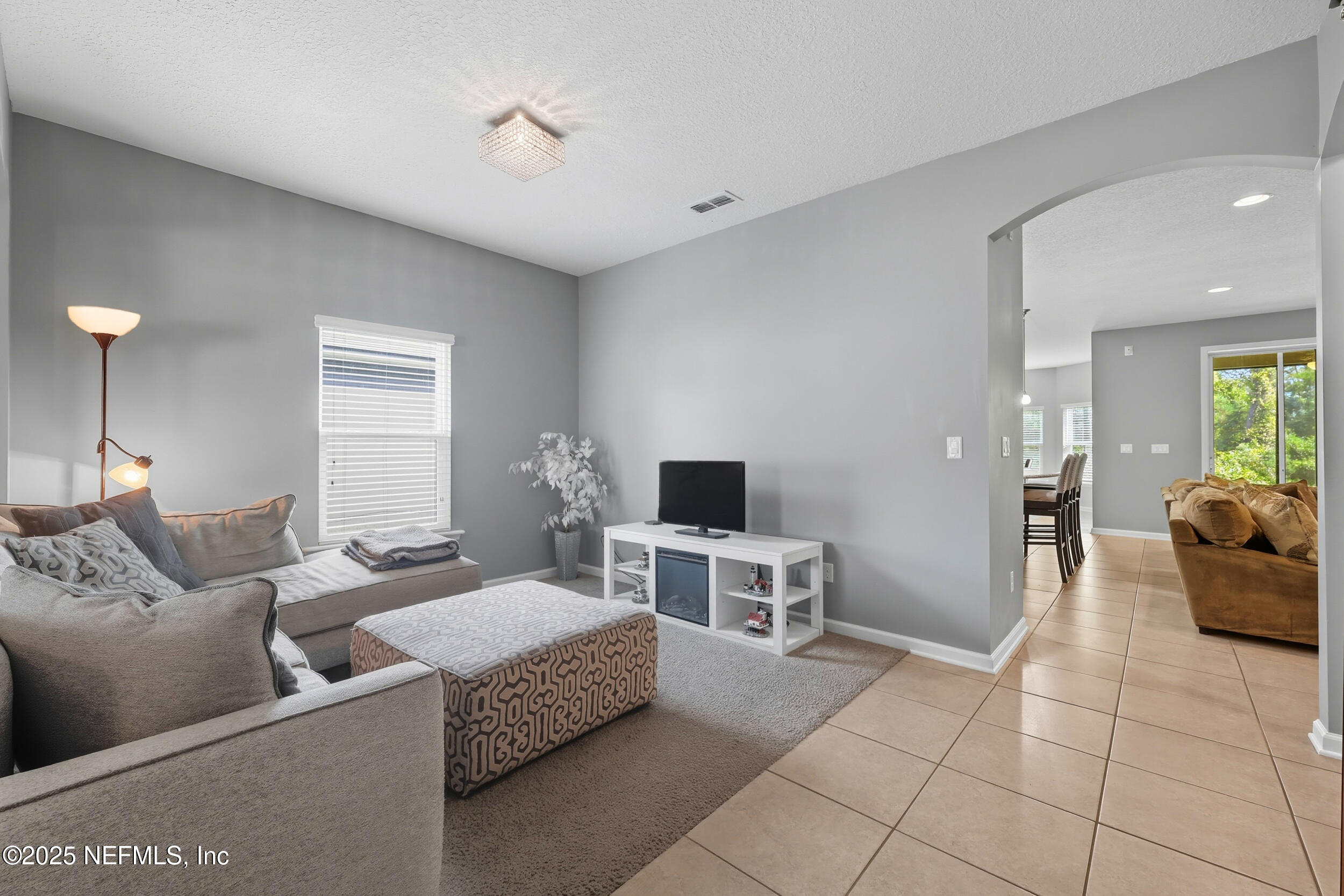 1218 Wetland Ridge Circle Middleburg, FL 32068 - Photo 10 of 75 a living room with furniture and a flat screen tv