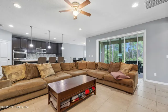 a living room with a bed furniture and a window