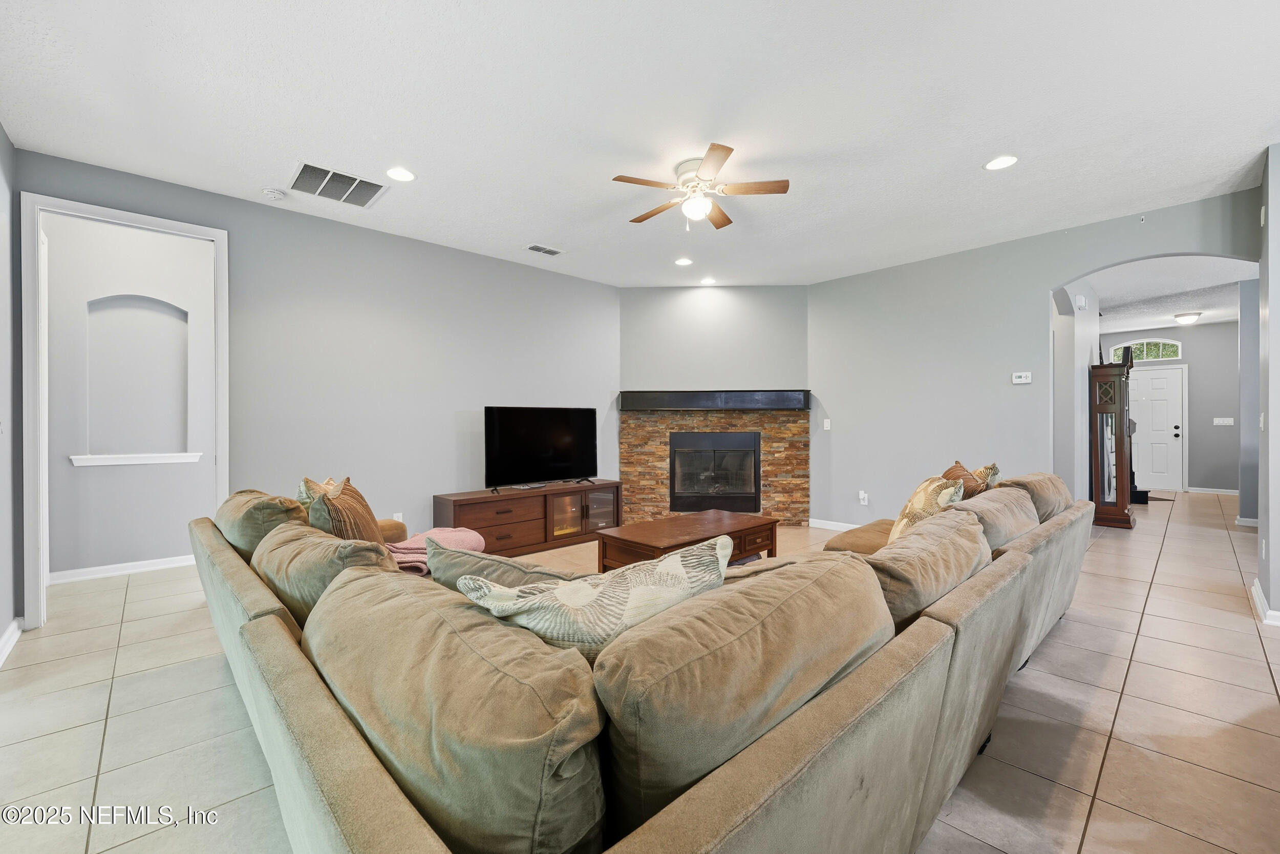 1218 Wetland Ridge Circle Middleburg, FL 32068 - Photo 17 of 75 a living room with furniture a ceiling fan and a flat screen tv