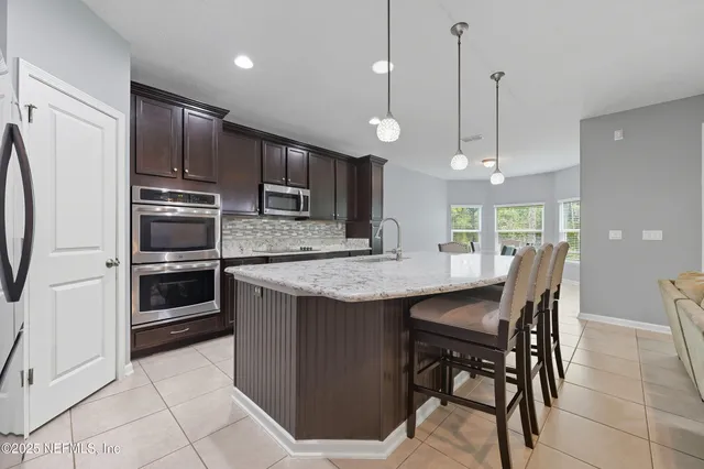 a bathroom with a sink a toilet and shower curtain