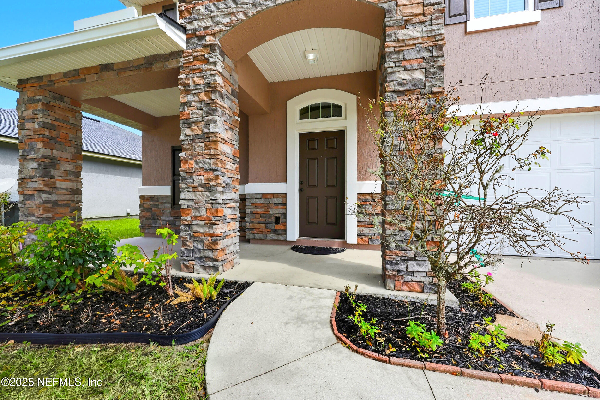 1218 Wetland Ridge Circle Middleburg, FL 32068 - Photo 3 of 75 a front view of a house with a garden