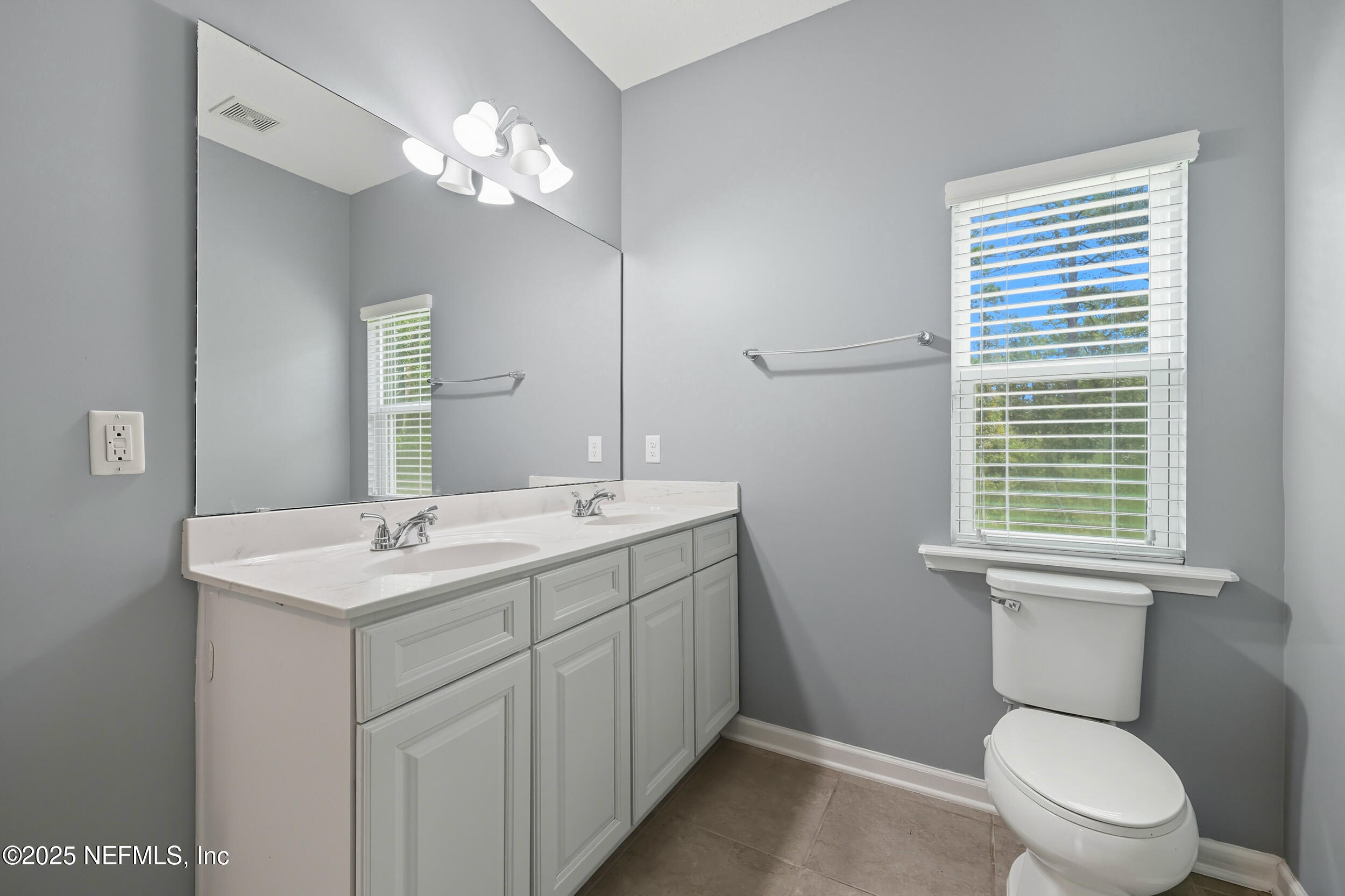 1218 Wetland Ridge Circle Middleburg, FL 32068 - Photo 30 of 75 a bathroom with a toilet sink and mirror