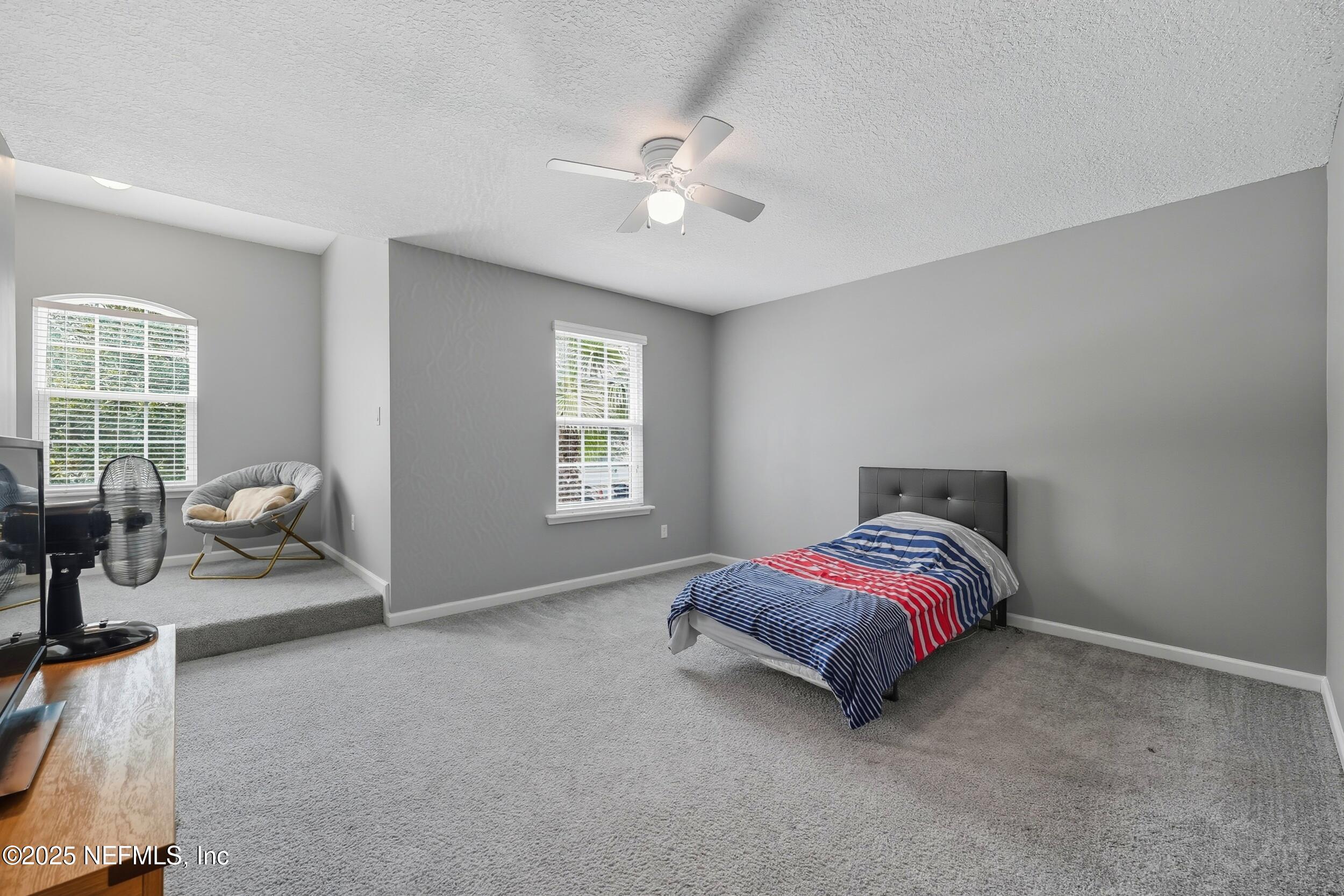 1218 Wetland Ridge Circle Middleburg, FL 32068 - Photo 45 of 75 a living room with a bed furniture and a window