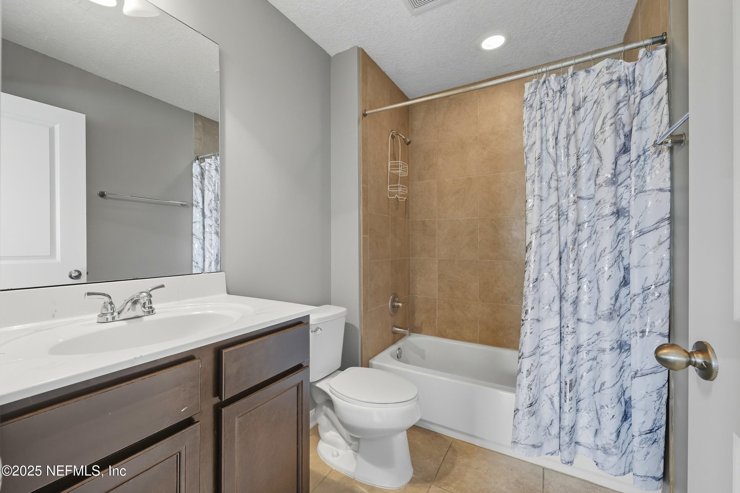 1218 Wetland Ridge Circle Middleburg, FL 32068 - Photo 52 of 75 a bathroom with a sink a toilet and shower curtain
