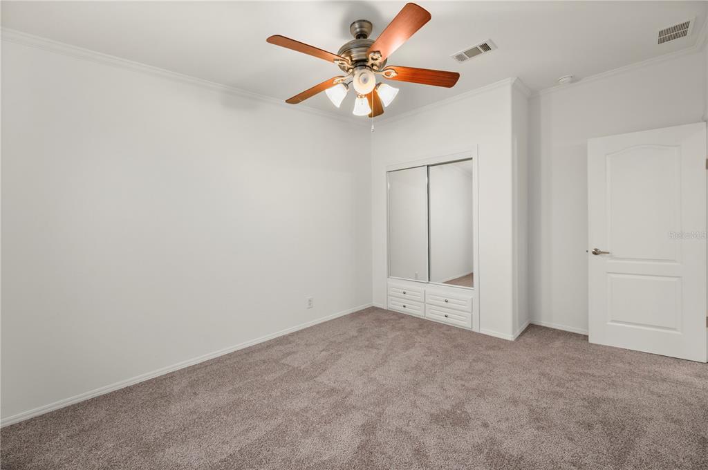 67 Windmill Boulevard Punta Gorda, FL 33950 - Photo 22 of 70 an empty room with fan and windows