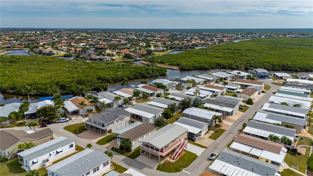 67 Windmill Boulevard Punta Gorda, FL 33950 - Photo 32 of 70 an aerial view of a city with lots of residential buildings and mountain view in back