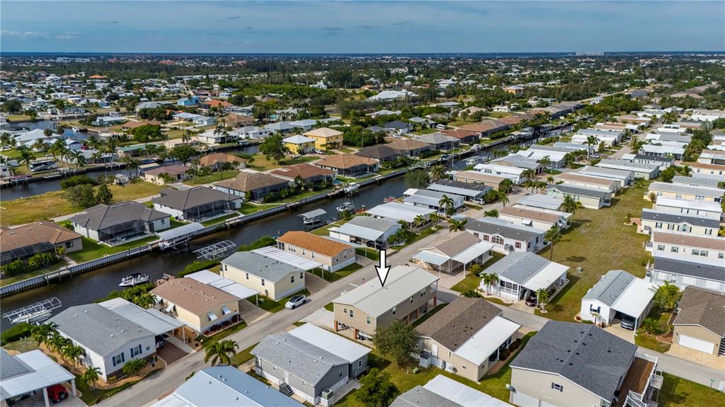 67 Windmill Boulevard Punta Gorda, FL 33950 - Photo 36 of 70 an aerial view of a city with lots of residential buildings and mountain view in back